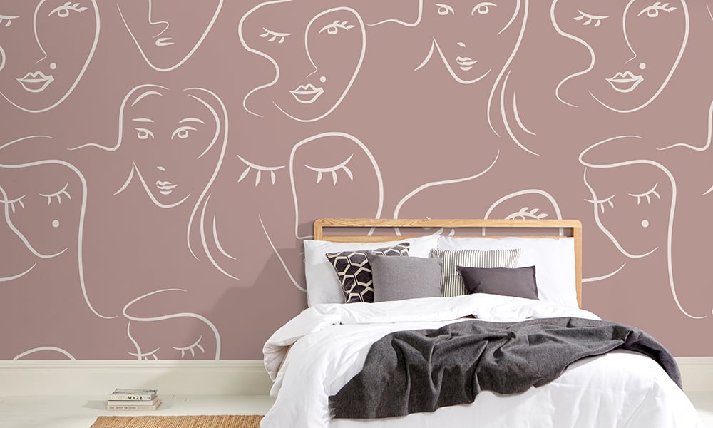 White female faces pattern on red wallpaper in bedroom - large scale