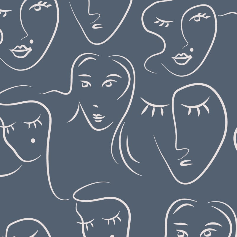 White faces pattern on blue background wallpaper situated in bedroom setting
