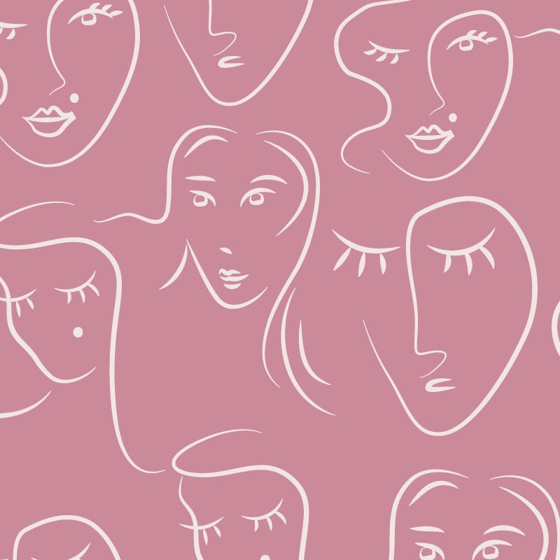 White faces pattern on pink background wallpaper situated in bedroom setting