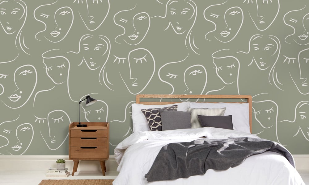 White female faces pattern on green wallpaper in bedroom - medium scale